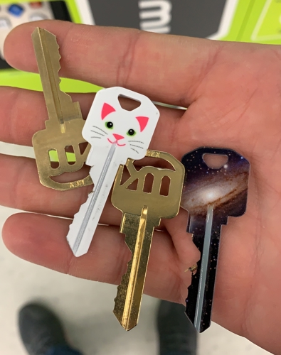 keys options  three custom keys with cat and galaxy designs for residential or office locks.
